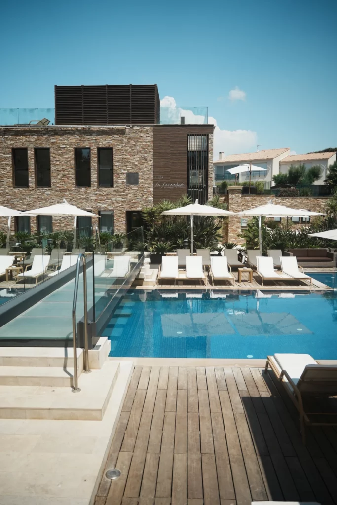 Pool and walkway in front of La Farandole’s stone façades in Bandol