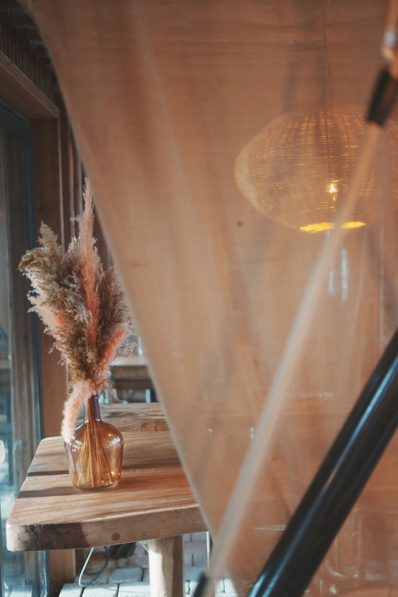 An amber vase and a reflected pendant light &mdash; Villa Occitana